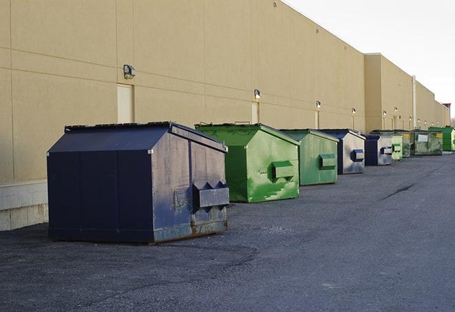 a construction worker disposing of debris into a dumpster in Bennet NE